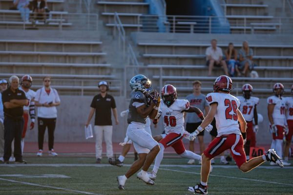 El Camino wide receiver Mark Baker gets a huge gain of 47 yards and gets taken down on the Santa Barbara 45 yard line at Murdock Stadium on Aug. 30. Baker and the Warriors had a dominant performance with a 68-6 win over SBCC. (Ryan Hirabayashi | The Union)