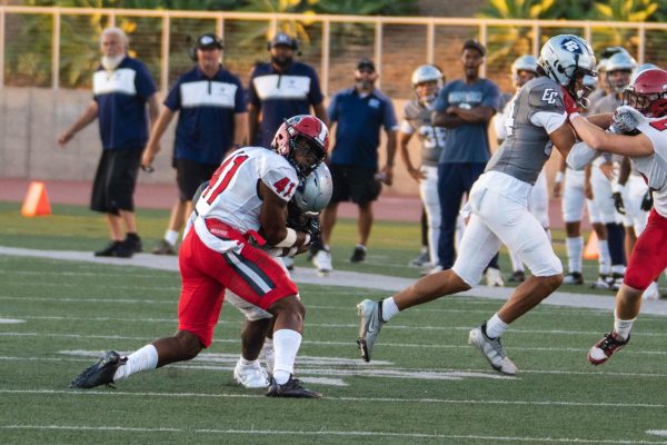 El Camino running back Azeon Nelson trucks Santa Barbara defensive back Tamarian Bickham and gets the 12-yard gain at Murdock Stadium on Aug. 30. (Ryan Hirabayashi | The Union)