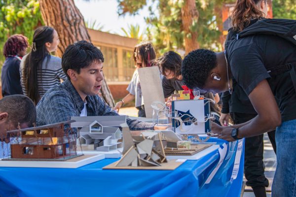 El Camino College student Angel Zaragoza speaks to students about architectural models during the fall 2025 club rush at the ECC Schauerman Library lawn on Monday, Sept. 8, 2025. The club offers interactive and collaborative drawing classes, provides architecture and firm tours, and creates models that evolve over time. (Ryan Hirabayashi | The Union)