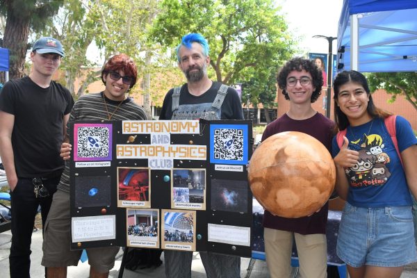 (L-R) Club members communications and business major Max Sapper, 25; physics major Greyson Mor, 20; computer science major and head astronomer Travis Beagley, 45; physics major and club president Matteo Merlo, 19; and biology major Sarah Harati, 21 represent the Astronomy and Astrophysics Club on Wednesday, Sept. 10. The club meets from 1:15 to 2:15 on Thursdays in the Planetarium. (Nikki Yunker | The Union)