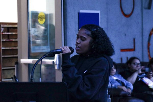 Shayla Garcia, 21, an astrophysics major and lead singer for the Cosmic Thorns, embraces the music as she passionately sings during the Battle of the Bands event near the Arts Building on Nov. 12. (Donovan Harris | The Union)