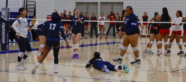 On Nov. 5, ECC Warriors team player 12, Justine Sapitanan, got knocked down while trying to hit the ball in the opposing teams court during the last quarter of the Volleyball game that took place in the gym located next to the Murdock stadium. (Madison Moody | The Union)