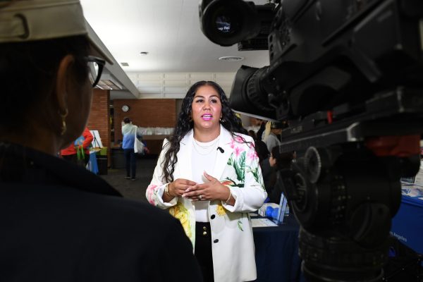 FamilyU Fellow Maria Lopez is interviewed by NBC4 photographer Azucena Varela during the Parents to Bee community baby shower at the El Camino College Shauerman Library's Collaboration Room on Wednesday, Nov. 19. (Nikki Yunker | The Union)