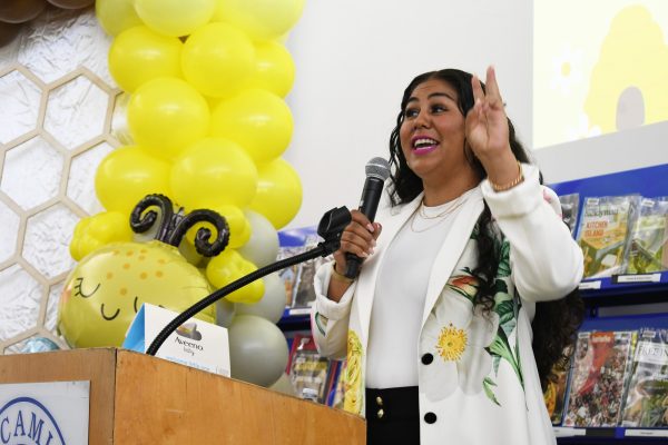 FamilyU Fellow Maria Lopez announces a raffle giveaway for a Target gift card and Aveeno products during the Parents to Bee community baby shower at the El Camino College Shauerman Library's Collaboration Room on Wednesday, Nov. 19. (Nikki Yunker | The Union)