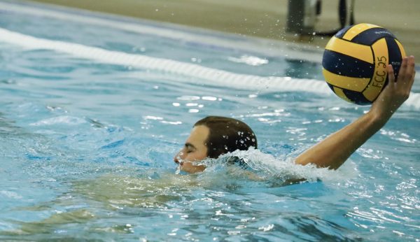 ECC Waterpolo Warrior, Cooper Josic, 19, practices passes with teammates during practice on Thursday, Oct. 23 at the Aquatics Center. (Savannah Anderson | The Union)