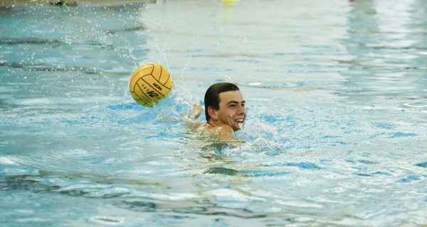 ECC Waterpolo Warrior, Cooper Josic, 19, smiles during practice on Thursday, Oct. 23 at the Aquatics Center. (Savannah Anderson | The Union)