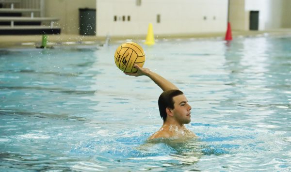 ECC Waterpolo Warrior, Cooper Josic, 19, practices passes with teammates during practice on Thursday, Oct. 23 at the Aquatics Center. (Savannah Anderson | The Union)