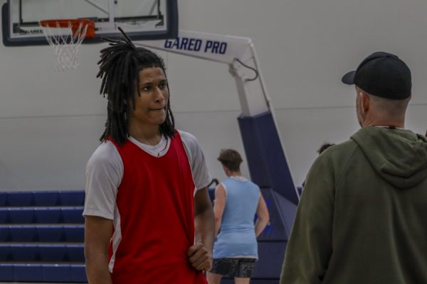 Joshua Bada gets coached up by El Camino basketball coach Robert Uphoff in between drills at practice on Dec. 4 at the Gym Complex. (Donovan Harris | The Union)