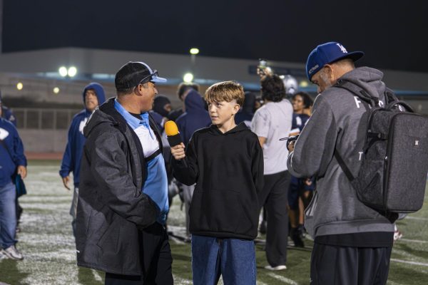 Wesley Turner and his father, Matthew Turner, interview El Camino College's football head coach, Gifford Lindheim, after an ECC win over Riverside City College on Saturday, Nov. 1, 2025. (Ryan Hirabayashi | The Union)