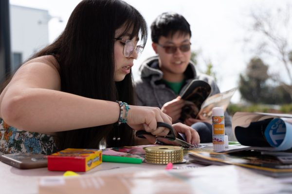 Education major Isabelle Estrada, 18, uses scissors while putting together a vision board project at the El Camino College Center for Well-Being on Tuesday, Feb. 24. Estrada said she wants more nature and art in her life this year and plans to visit Hawaii. (Nikki Yunker | The Union)