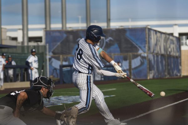 El Camino College centerfielder Dane Rhodes singles through third with the bases loaded and earns one RBI at the ECC baseball field on Tuesday, Feb. 24. Rhodes finished the game with one hit and one RBI. (Ryan Hirabayashi | The Union)