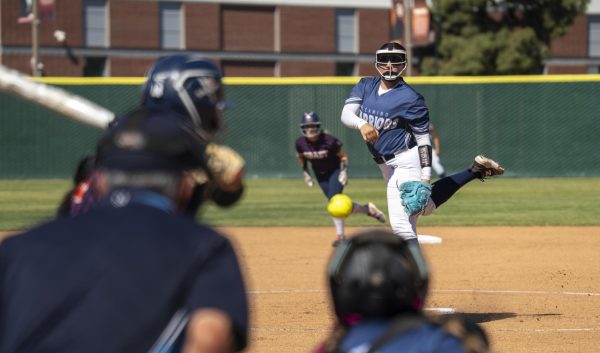 El Camino College Sophomore pitcher Mahlia Espino delivers a pitch during the top of the first inning with runners on base against Orange Coast at the ECC softball field on Wednesday, March 18. Espino ended the game allowing only 7 hits. (Gael Gallardo | The Union)