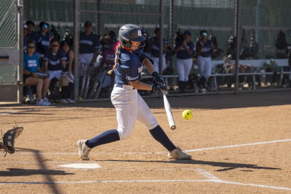El Camino College right-handed batter Trinity Martinez makes contact at the plate and takes first base against Orange Coast on Wednesday, March 18. (Gael Gallardo | The Union)