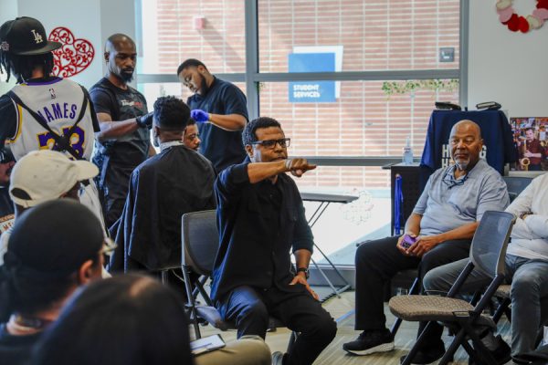 Rickerby Hinds speaks to a group during a Barbershop Talk in the Student Services Building on Feb. 25. (Donovan Harris | The Union)