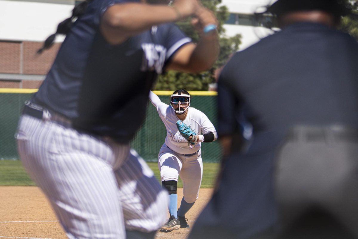 El Camino College right-handed pitcher Mahlia Espino throws the ball to LA Mission College firstbaseman Victoria Gomez at the ECC softball field on Saturday, March 7. Espino finished the game with four strikeouts in the opener of the Warriors' doubleheader. (Ryan Hirabayashi | The Union)