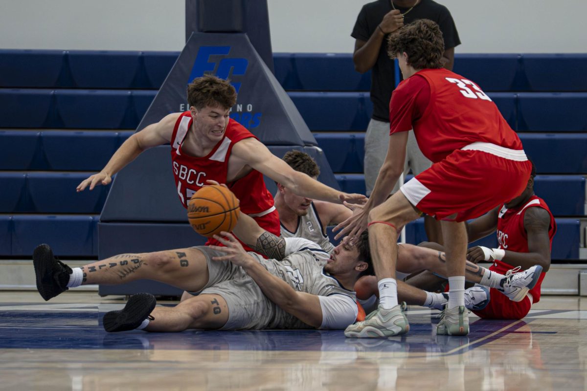 El Camino Sophomore Guard Vaitai Tuione gets on the floor for a loose ball and passes it to an open teammate at the ECC Gymnasium on Friday, Oct. 31. This photo earned Ryan Hirabayashi second place for Best Sports Photography at the California College Media Association Awards and fourth place at the Journalism Association of Community Colleges conference. (Ryan Hirabayashi | The Union)