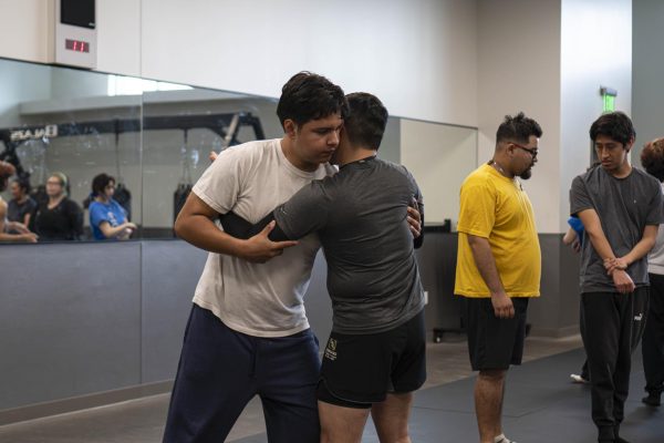 (L-R) David Alvarez, an accounting major, and Carlo Enad, a cybersecurity major, are drilling out "pummelling" in their self-defense class at El Camino on Wednesday, March 4. Pummelling is a grappling technique to get double underhooks to control the attacker&squot;s posture to prevent strikes. (Ryan Hirabayashi | The Union)