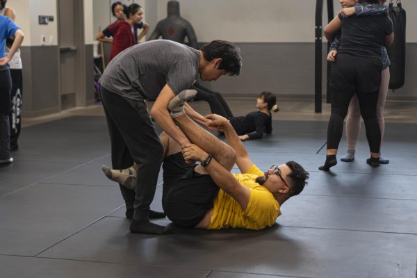 (L-R) Julio Martines, HVAC major, and Moises Peña, film and art major, participate in their self-defense class at El Camino College on Wednesday, March 4. (Ryan Hirabayashi | The Union)