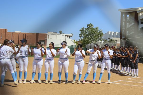 The El Camino College Warriors and Long Beach City College Vikings line up introducing their players before the match starts on March 24. Players go down the line to give each other high fives to build up their team’s energy. (Frances Que | The Union)