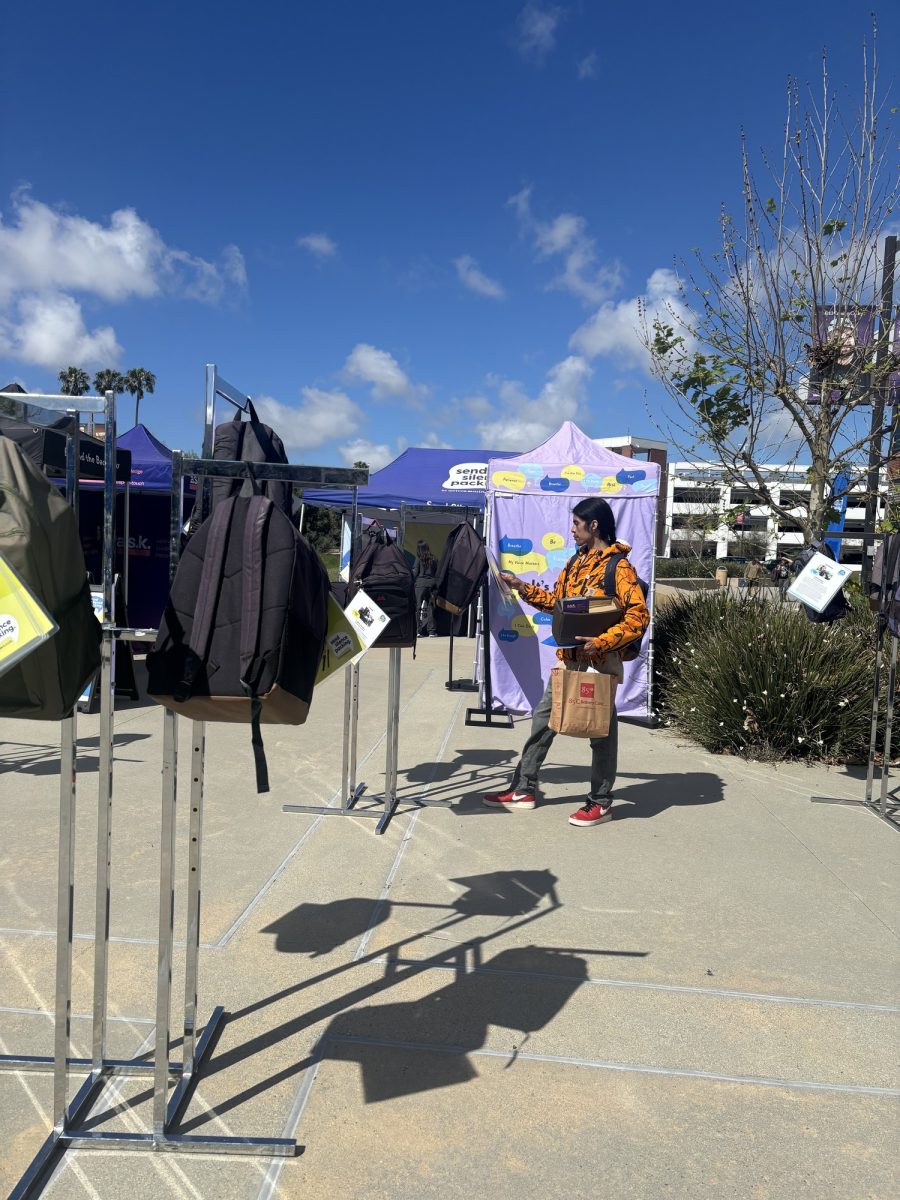 A student reads the impactful stories from the exhibit Send Silence Packing Wednesday, April 1. These stories highlight hope and loss of the lives lost to suicide. The exhibit was part of the Saving Lives, Supporting Minds: A Suicide Prevention and Well-Being Fair. (Ana Gamez | The Union)
