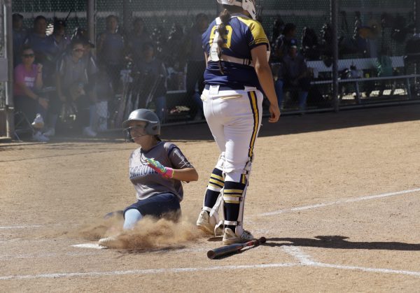 El Camino Warriors catcher and outfielder Bryanna Morales slides safely into home plate against the L.A. Harbor Seahawks Tuesday, April 7. Morales scored the game-winning run in the bottom of the fifth inning, crossing the plate on a clutch single by Gabby Merced. Her aggressive base running triggered the run rule, ending the contest early and securing the season sweep for the Warriors. The Warriors' steady performance provided the foundation for their decisive 10-2 victory over their conference rivals. (Mun Leong | The Union)