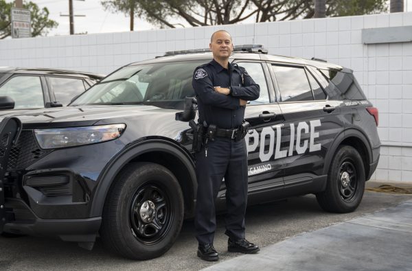 Officer Pablo Garcia, 44, poses in front of a patrol vehicle at the El Camino College Police station. Garcia brings years of law enforcement experience to the department as he trains alongside Officer Ryan Brown while continuing to serve the community. (Gael Gallardo | The Union)