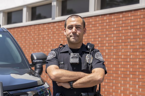 Officer Ryan Brown with the El Camino College Police Department stands beside a police car on Thursday, April 30. Brown is a Lawndale native and former cadet at the ECC Police Cadet Program recently sworn in on Thursday, April 2. He acquired a administration of justice degree from (Gael Gallardo | The Union)