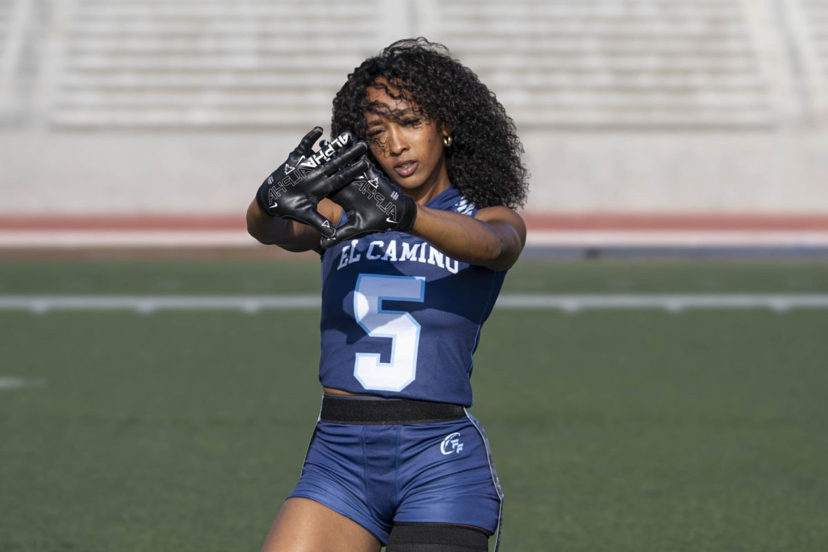 El Camino College Warriors flag football player Cydney Kone looks through her hands up at Murdock Stadium on Wednesday, March 25. (Ryan Hirabayashi | Warrior Life)