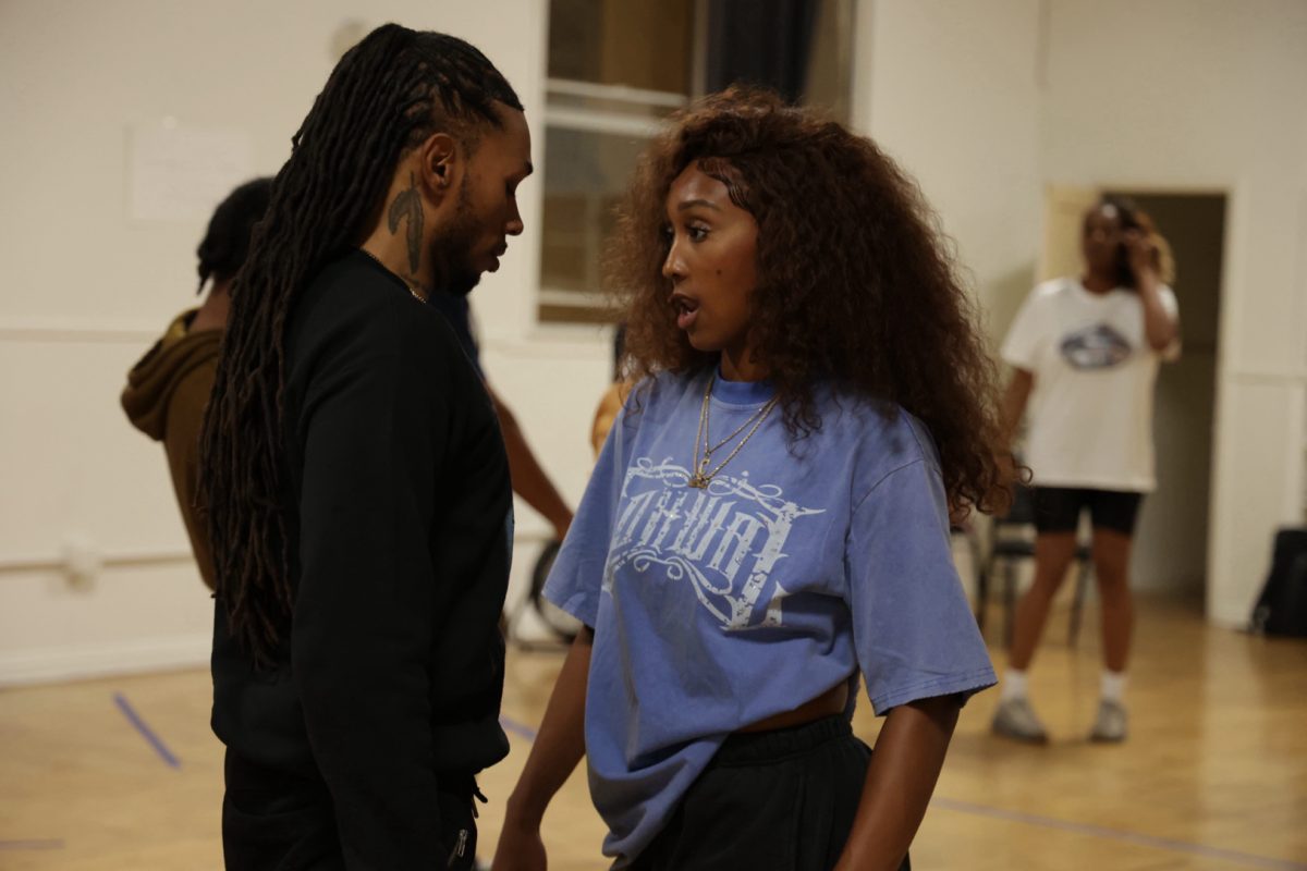 Cydney Kone dances with scene partner Tyrelle Williams during a rehearsal for the musical "Born 2 Reign" at the Ashanti United Church of Christ on Thursday, April 23. Photo credit: Savannah Anderson