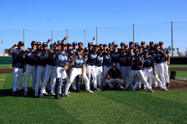 The Warriors pose in the center of the El Camino College baseball field with pride and smiles after a winning victory against the Pasadena City College Lancers, Friday, April 24. (Patrick Martinez | The Union).