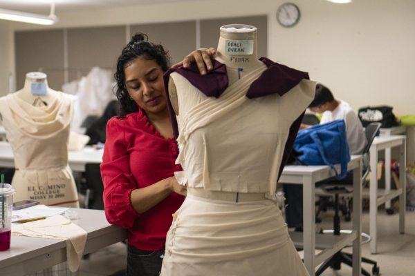 El Camino College student Odali Duren, a fashion major, works on the back of her cowl neck dress at the ITEC building on Monday, March 30. (Ryan Hirabayashi | The Union)