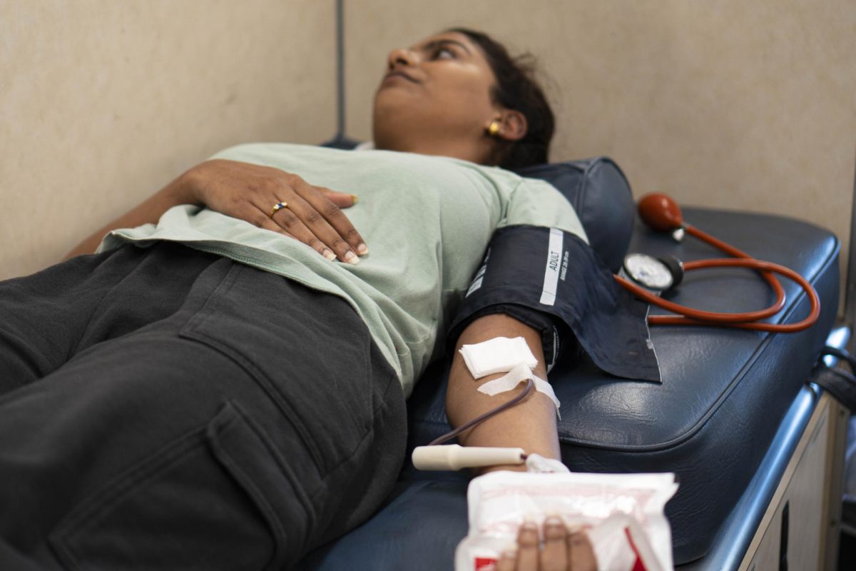 El Camino College student Kyi Naing, a business major, draws blood at a Cedars Sinai blood donation truck at ECC on Wednesday, April 8. (Ryan Hirabayashi | The Union)