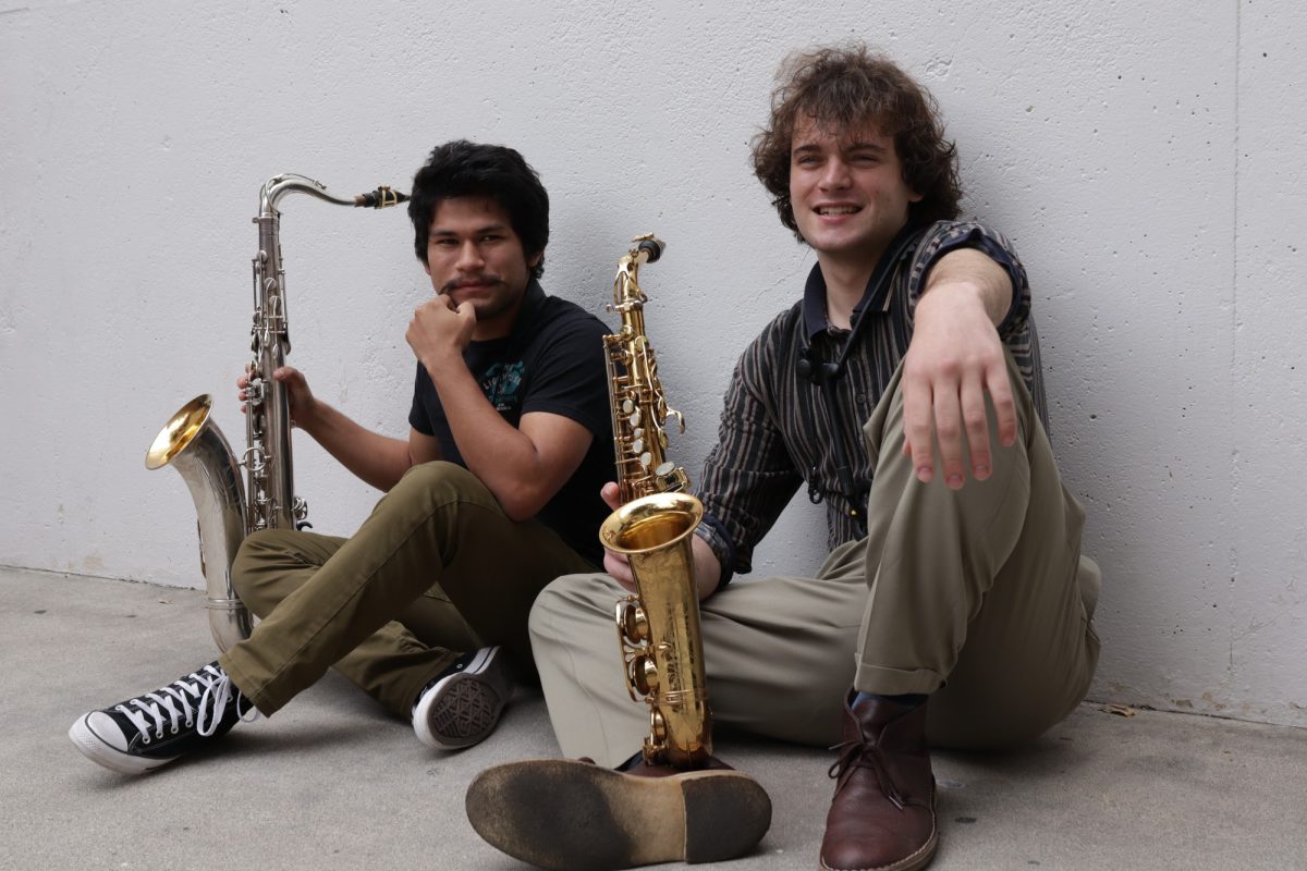 Music majors Alejandro "Alex" Gonzalez, 20, and Aidan Jennings, 21, chill on the ground at the Music Building with their instruments in hand April 21. (Patrick Martinez | Warrior Life)